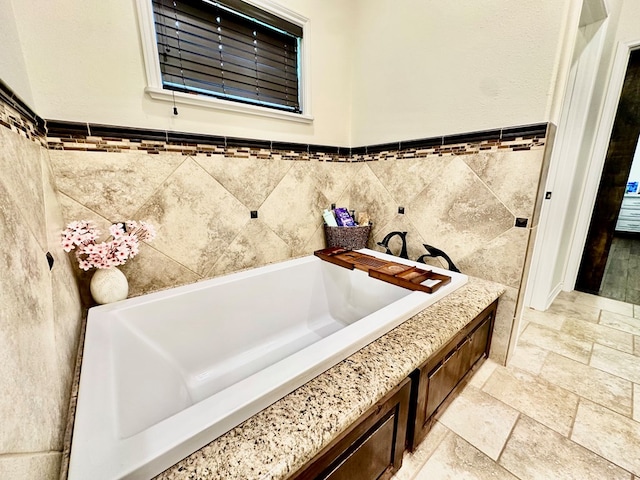 4815 Fm 2827, Warren, TX 77664 - full bath with tile walls, stone tile floors, a bath, and wainscoting
