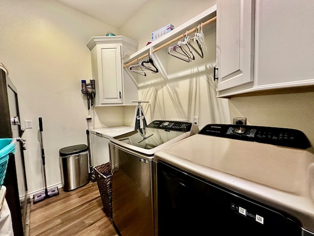 4815 Fm 2827, Warren, TX 77664 - laundry room featuring cabinet space, washing machine and clothes dryer, light wood-type flooring, and baseboards