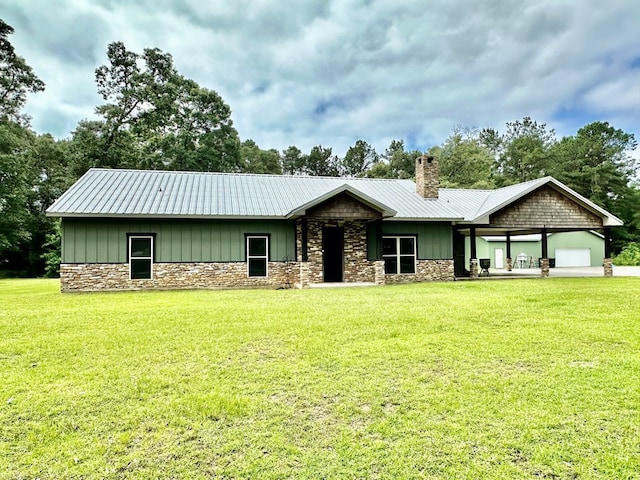 4815 Fm 2827, Warren, TX 77664 - view of front of property with stone siding, a chimney, a front lawn, and metal roof