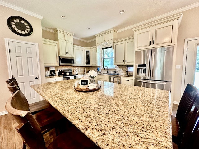 4815 Fm 2827, Warren, TX 77664 - kitchen with stainless steel appliances, cream cabinets, dark wood-style flooring, light stone counters, and crown molding