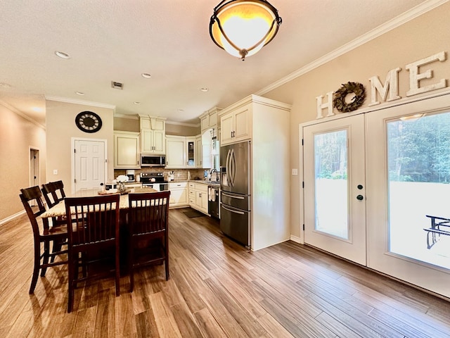 4815 Fm 2827, Warren, TX 77664 - dining area featuring crown molding, wood finished floors, french doors, and baseboards