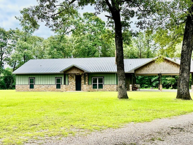 4815 Fm 2827, Warren, TX 77664 - view of front of house featuring board and batten siding, stone siding, a front yard, and metal roof
