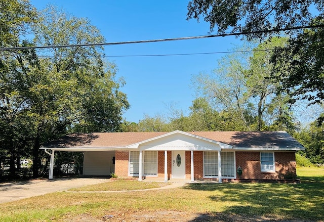 ranch-style house featuring a carport and a front lawn