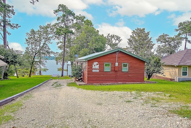 view of side of property with a yard