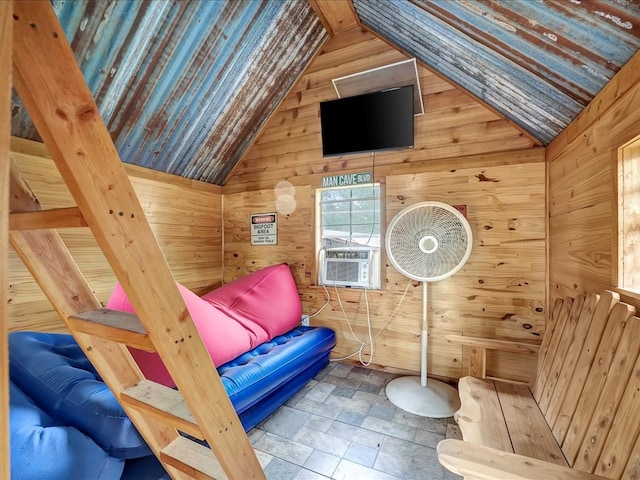 bedroom featuring cooling unit, lofted ceiling, and wood walls