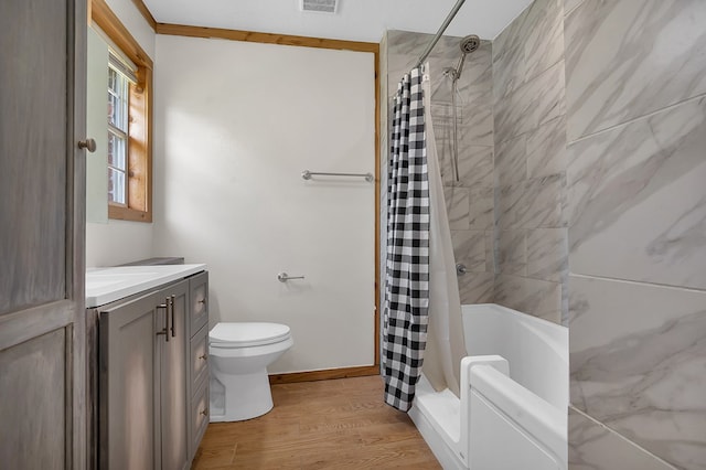full bathroom featuring vanity, baseboards, toilet, visible vents, and wood finished floors