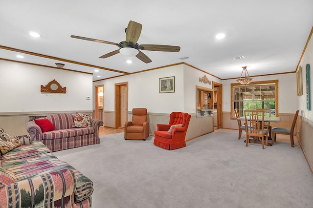 living area with visible vents, ornamental molding, recessed lighting, wainscoting, and light colored carpet
