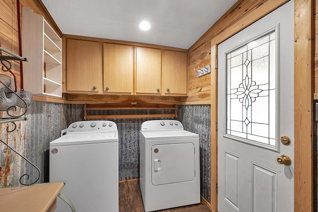 clothes washing area with washer and dryer, cabinet space, and a wealth of natural light