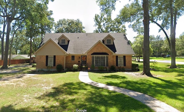 cape cod house with a front yard