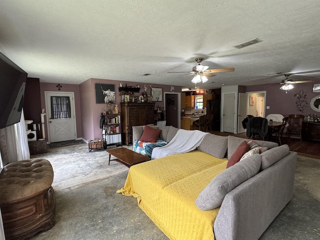 living room with concrete flooring, a textured ceiling, and ceiling fan