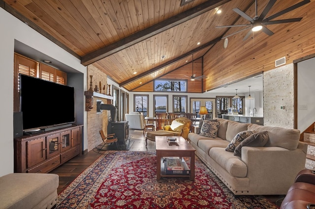 130 Boxwood Ln, Brookeland, TX 75931 - living room with ceiling fan, a wood stove, dark wood finished floors, a wood ceiling with exposed beams, and high vaulted ceiling