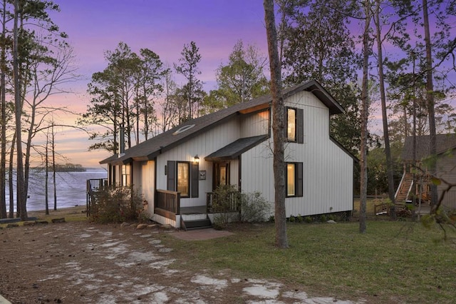 130 Boxwood Ln, Brookeland, TX 75931 - view of front of house with a water view, a front lawn, and roof with shingles