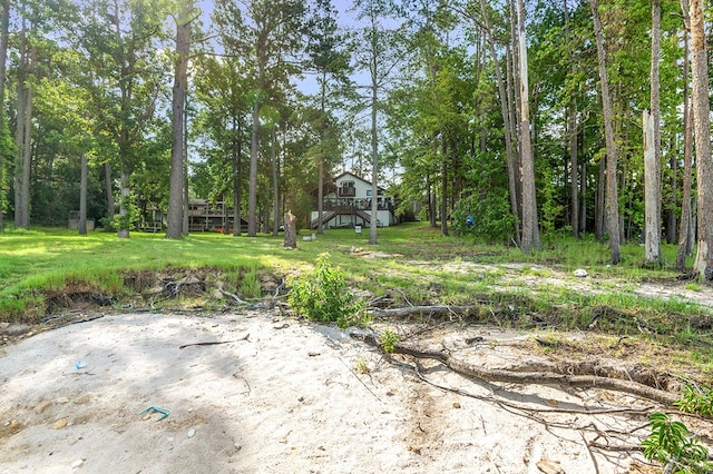 130 Boxwood Ln, Brookeland, TX 75931 - view of yard with stairway, a wooden deck, and view of scattered trees