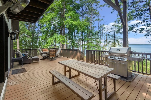 130 Boxwood Ln, Brookeland, TX 75931 - wooden deck with outdoor dining space, a grill, and a water view
