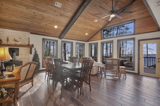 130 Boxwood Ln, Brookeland, TX 75931 - dining room with a wood stove, dark wood-type flooring, healthy amount of natural light, high vaulted ceiling, and a ceiling fan