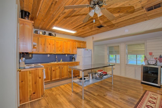 kitchen featuring wooden ceiling, white refrigerator, beverage cooler, and light wood-type flooring