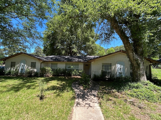 single story home with a front yard and brick siding
