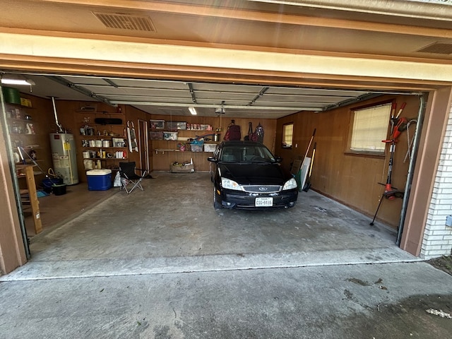 garage with visible vents and gas water heater