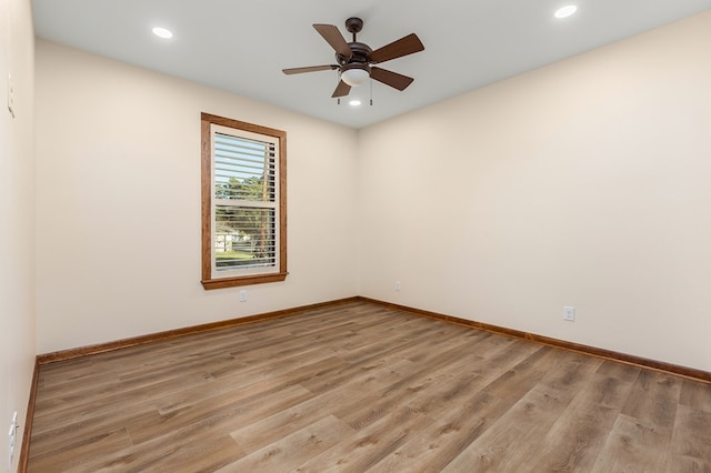 spare room featuring ceiling fan and light hardwood / wood-style floors