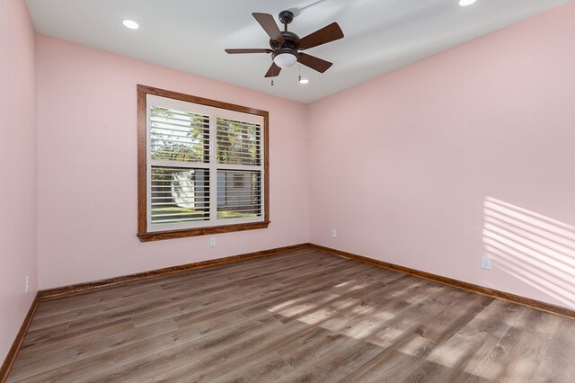 unfurnished room featuring hardwood / wood-style flooring and ceiling fan