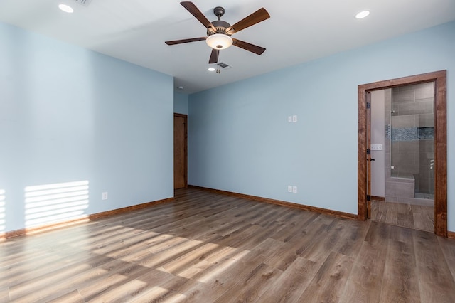 spare room with hardwood / wood-style flooring and ceiling fan