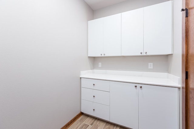 kitchen featuring white cabinets and light hardwood / wood-style flooring