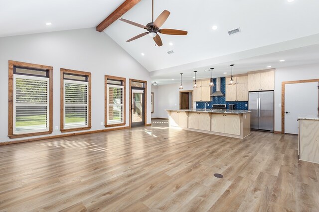 unfurnished living room featuring high vaulted ceiling, ceiling fan, a wealth of natural light, and light hardwood / wood-style flooring