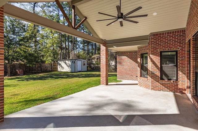 view of patio featuring ceiling fan and a shed