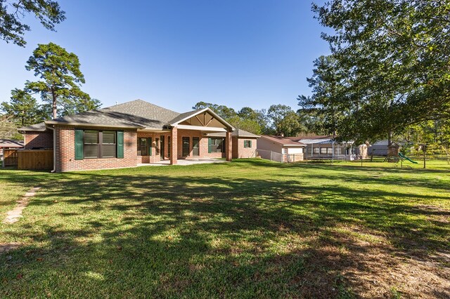 back of house with a lawn