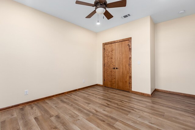 spare room featuring ceiling fan and light hardwood / wood-style floors