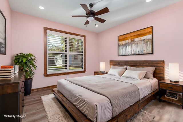 bedroom featuring hardwood / wood-style flooring and ceiling fan