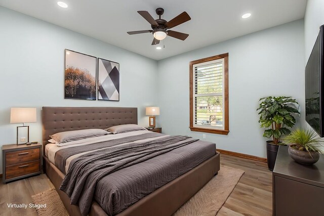 bedroom with light hardwood / wood-style flooring and ceiling fan