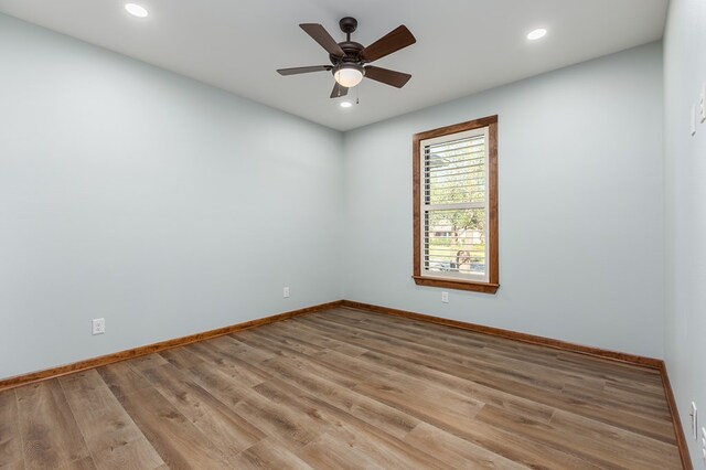 empty room with ceiling fan and light hardwood / wood-style floors