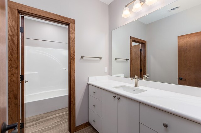 bathroom featuring a tub, vanity, and hardwood / wood-style flooring