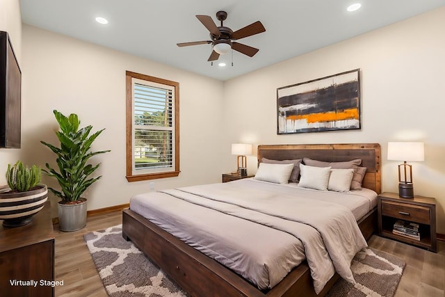 bedroom with light wood-type flooring and ceiling fan