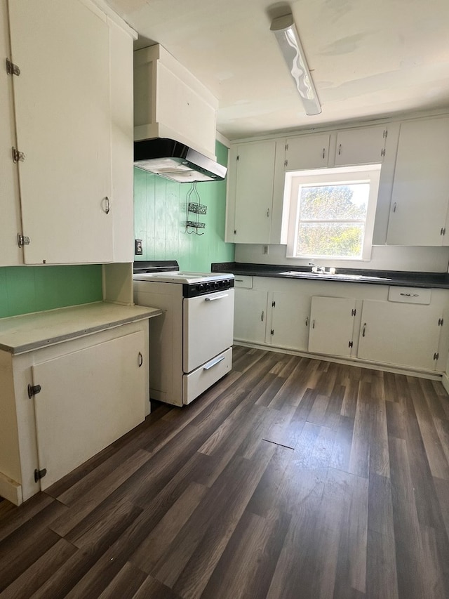 kitchen featuring ventilation hood, white cabinets, white range, and dark wood-type flooring