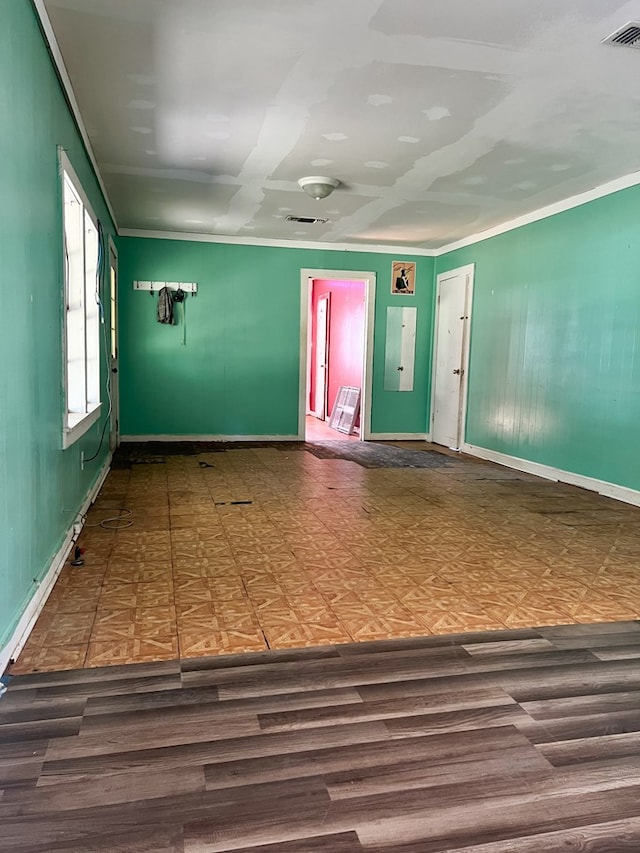 spare room featuring hardwood / wood-style floors and ornamental molding