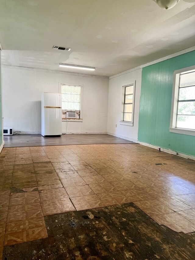 spare room featuring cooling unit and crown molding