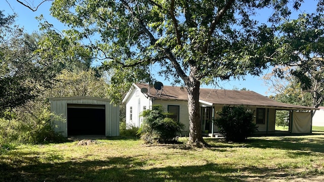 view of front of home with a front yard and an outdoor structure