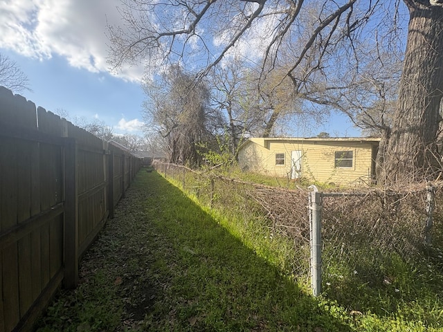 view of yard with a fenced backyard