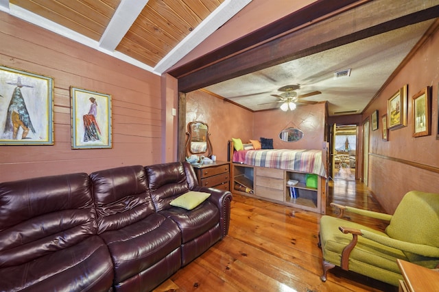 interior space featuring lofted ceiling with beams, ceiling fan, and wood-type flooring