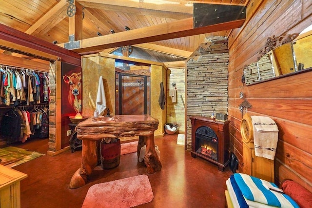 miscellaneous room with vaulted ceiling with beams, wood walls, and wood ceiling