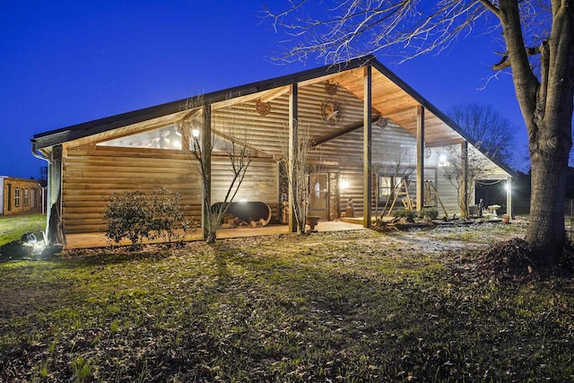 property exterior at night with an outdoor structure