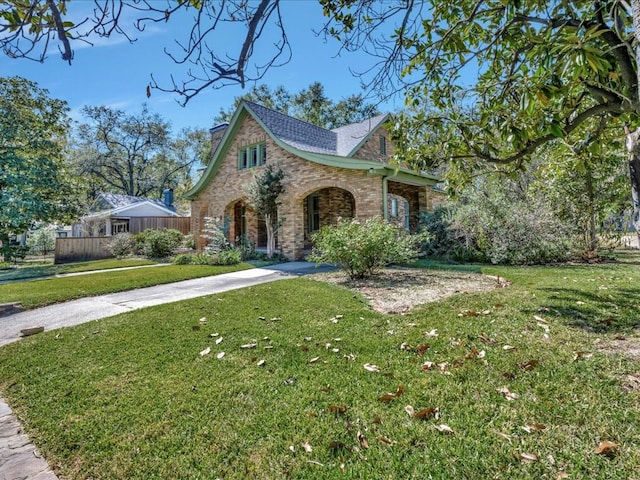 tudor house featuring a front lawn