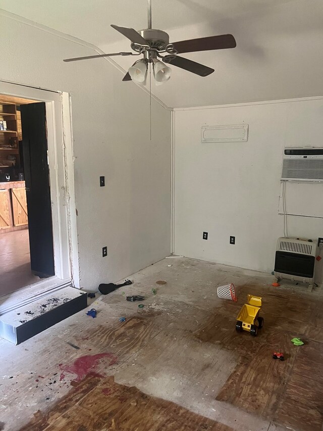 interior space featuring heating unit, ceiling fan, and a wall mounted air conditioner