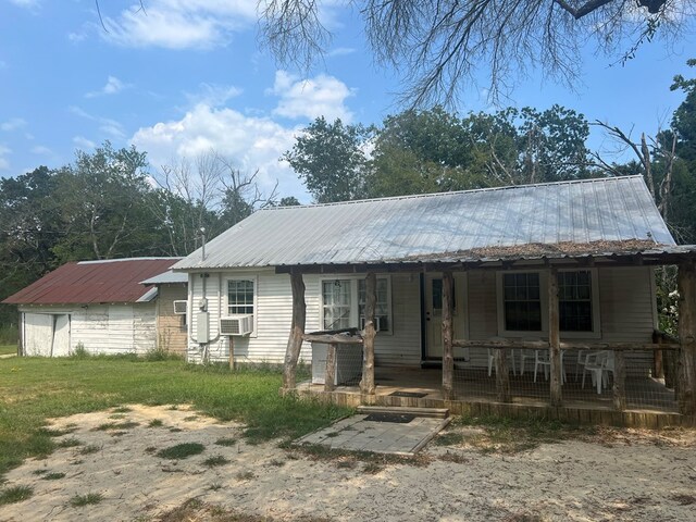 view of front of property with a porch and cooling unit