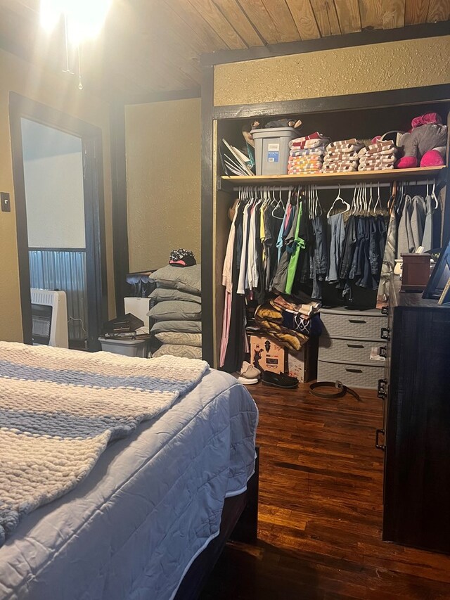 bedroom with wooden ceiling, a closet, and hardwood / wood-style floors