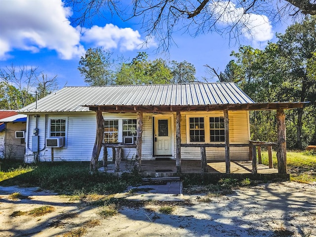 view of front of property with cooling unit and covered porch