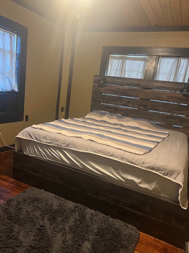 bedroom featuring hardwood / wood-style flooring and wood ceiling