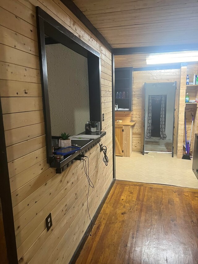 bathroom featuring hardwood / wood-style flooring, wooden ceiling, and wooden walls